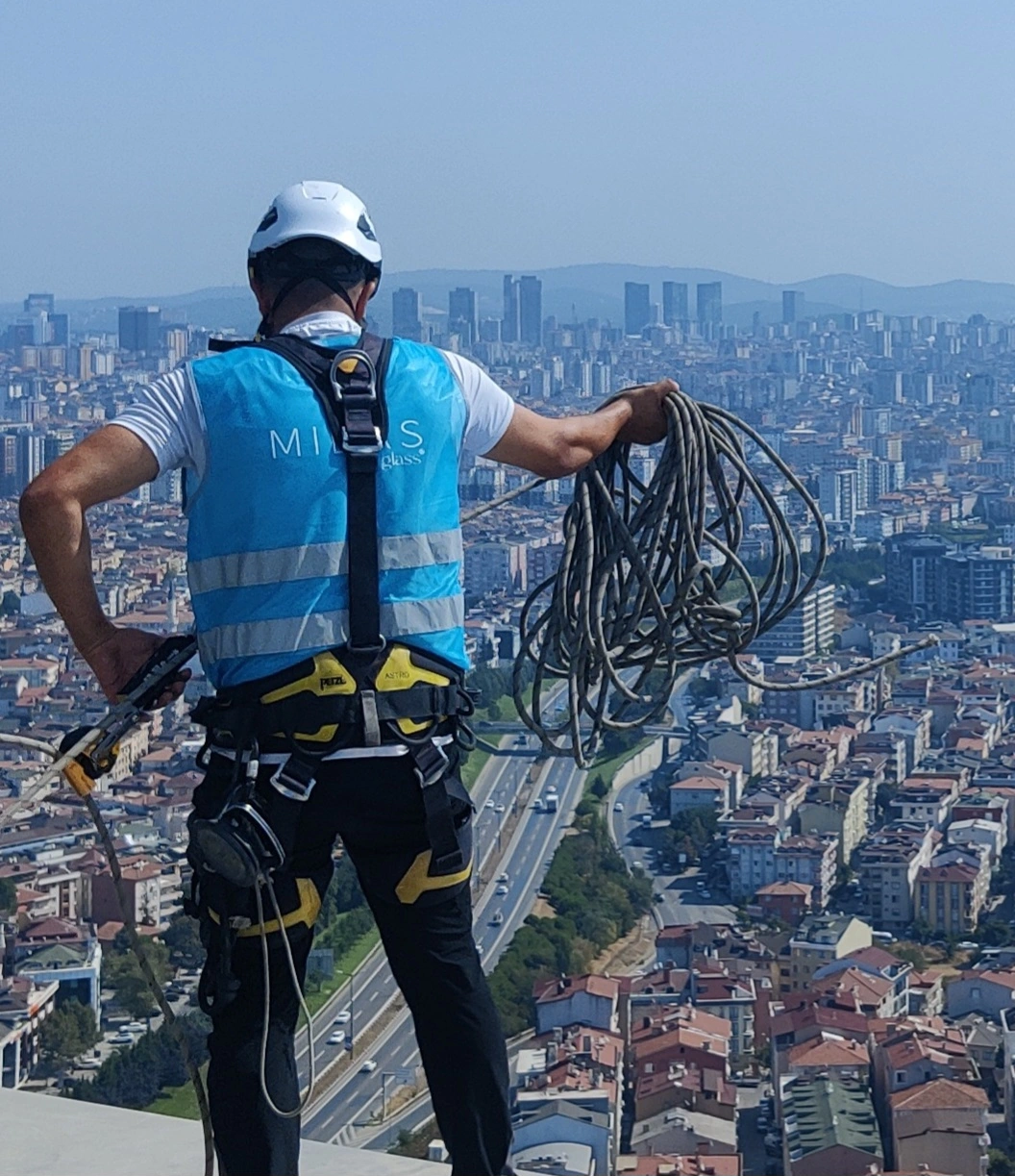 Industrial climbers installing glass on a skyscraper